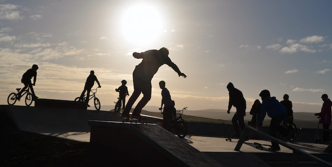 Silhouette of people using skatepark funded by Shetland LEADER