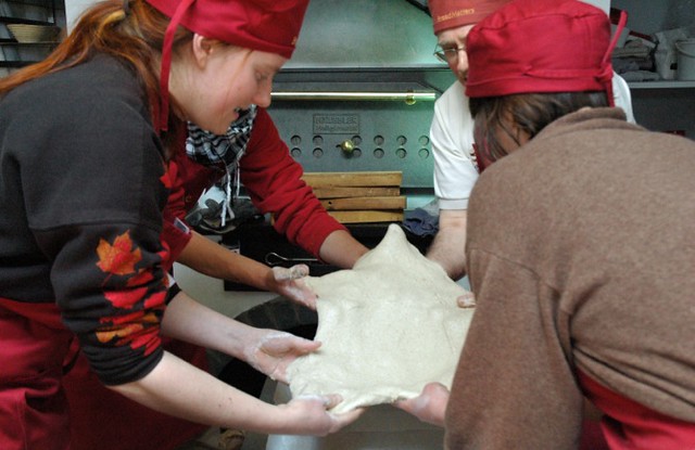 Group of bakers stretching dough