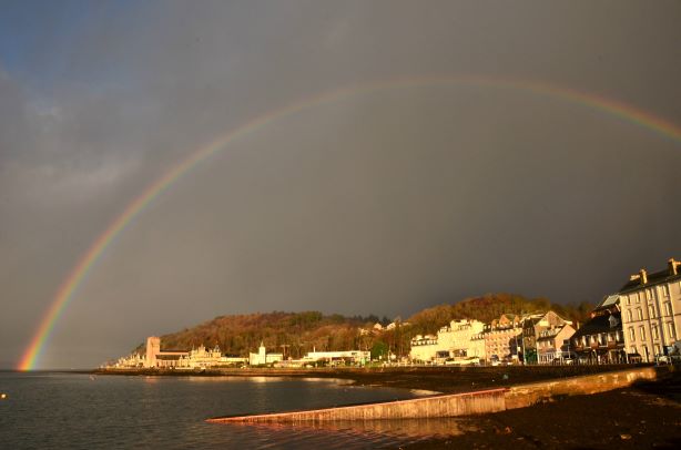 Dark sky with rainbow over Oban