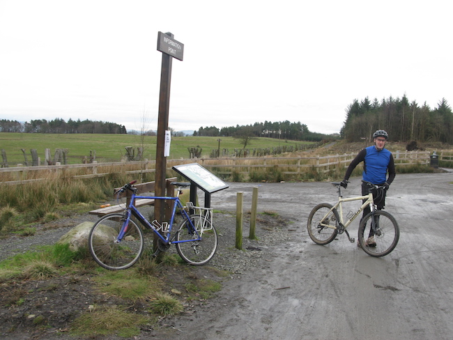 Man with bike standing on cycle path