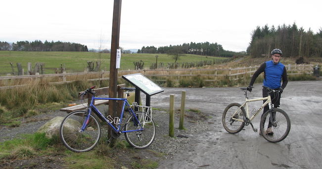 Man with bike on path with signs