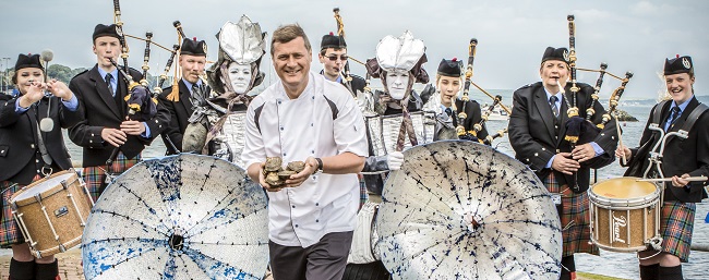 group photo with chef with oysters and pipe band