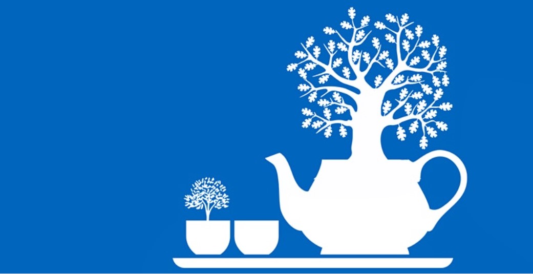 White silhouette of two teacups and teapot with trees growing from them