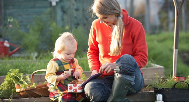 Woman and child having picnic in allotment