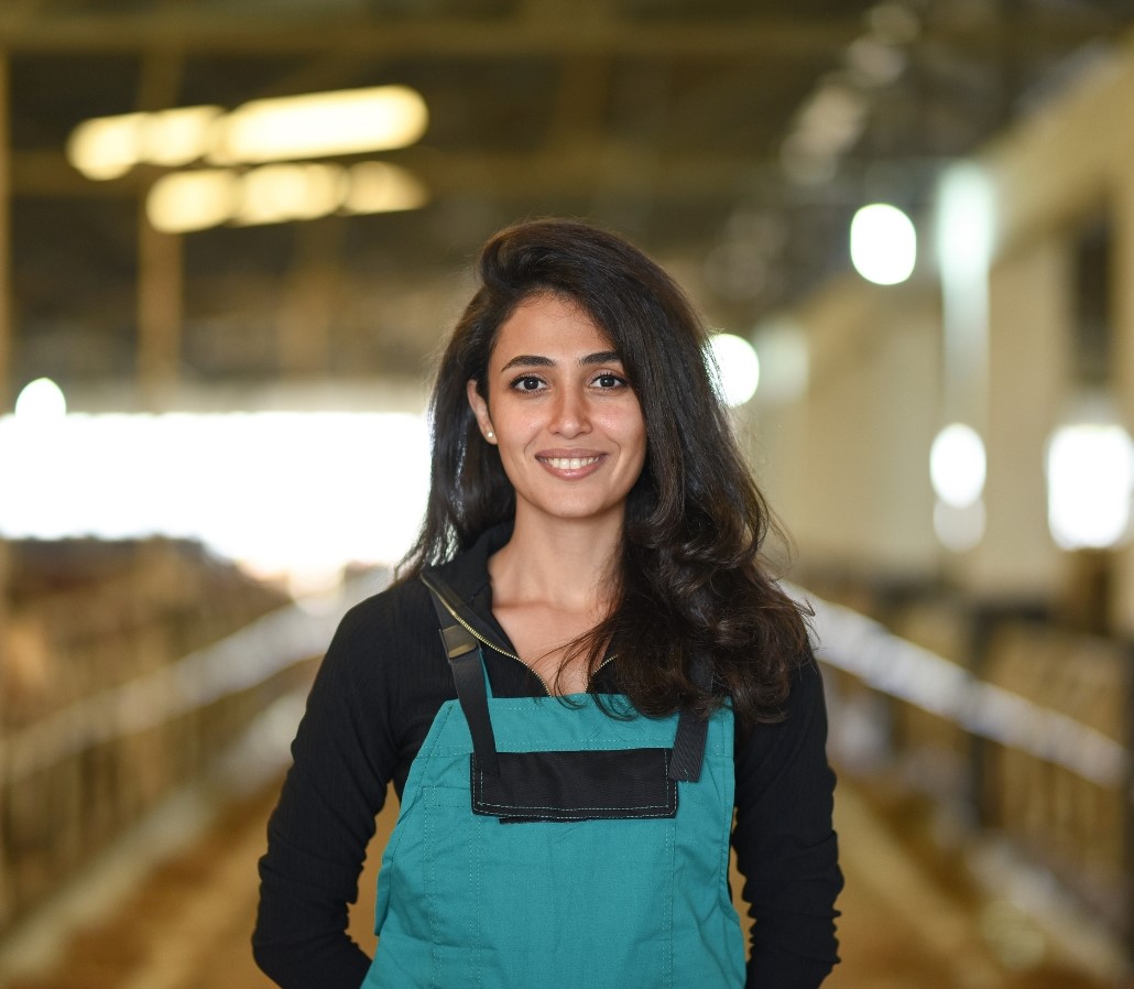 Young female farmer in farm building 