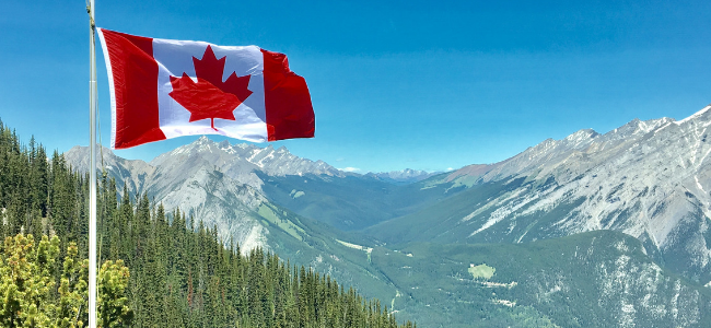 Canadian flag against mountain backdrop