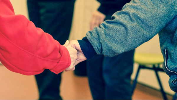 Older people holding hands