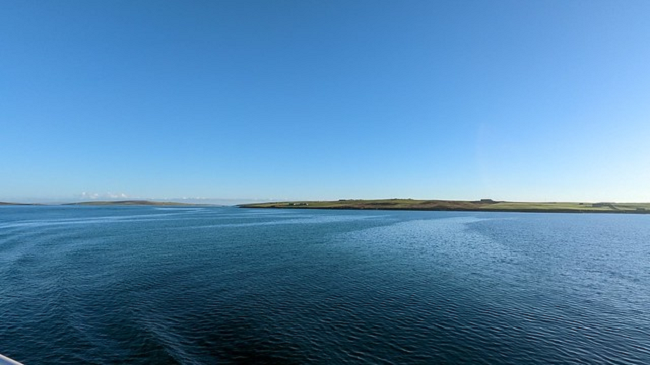 island land mass retreating into the distance with expanse of water in foreground