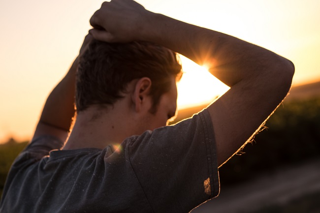 Man standing against sunlight