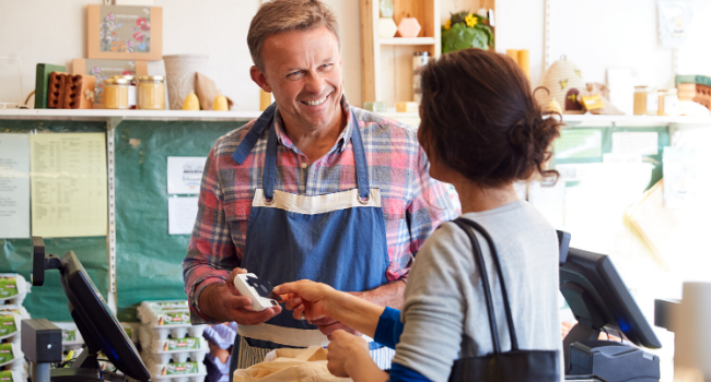 man serving customer in shop