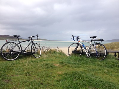 Two bikes parked by beach