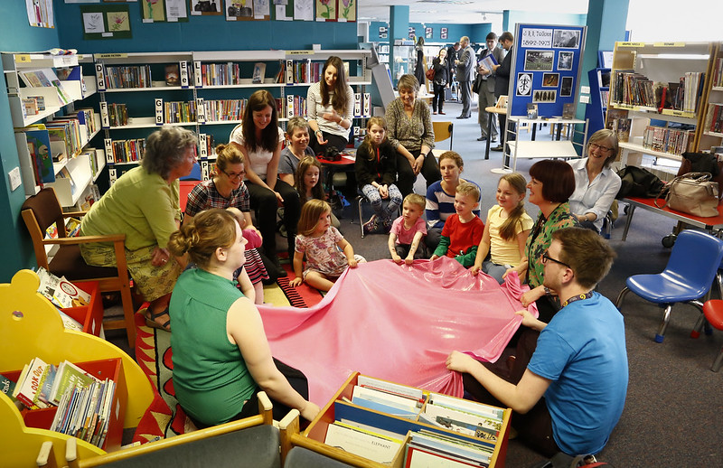 Group of children and carers in library