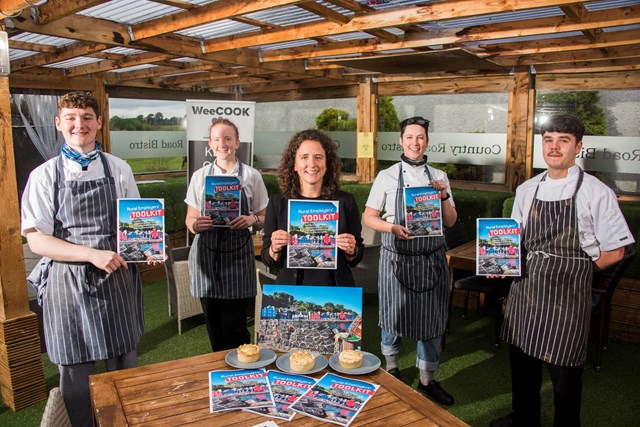 4 staff in chef's outfits holding copies of the new guide