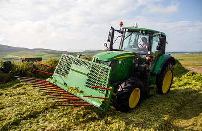 Woman driving a tractor in a silage pit