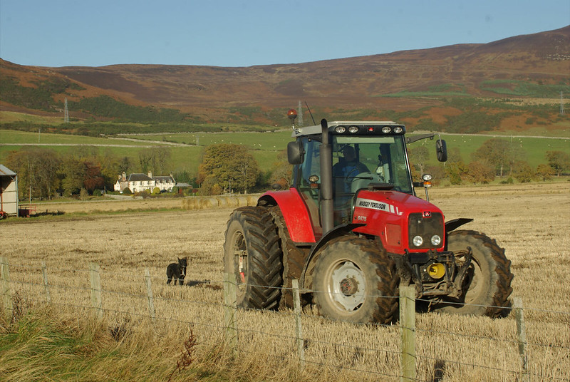 Farmer in tractor preparing field for ploughing