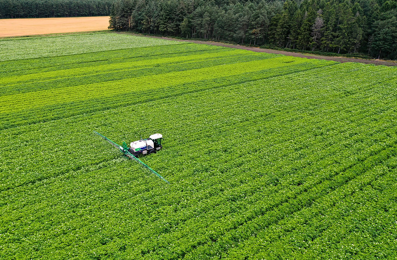 Arial shot of Spraying potato fields in Moray