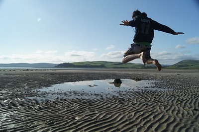 Boy jumping on beach
