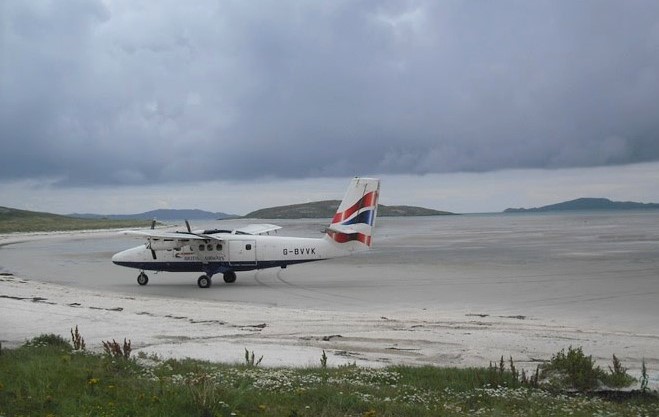 Wee plane landing on Barra beach runway