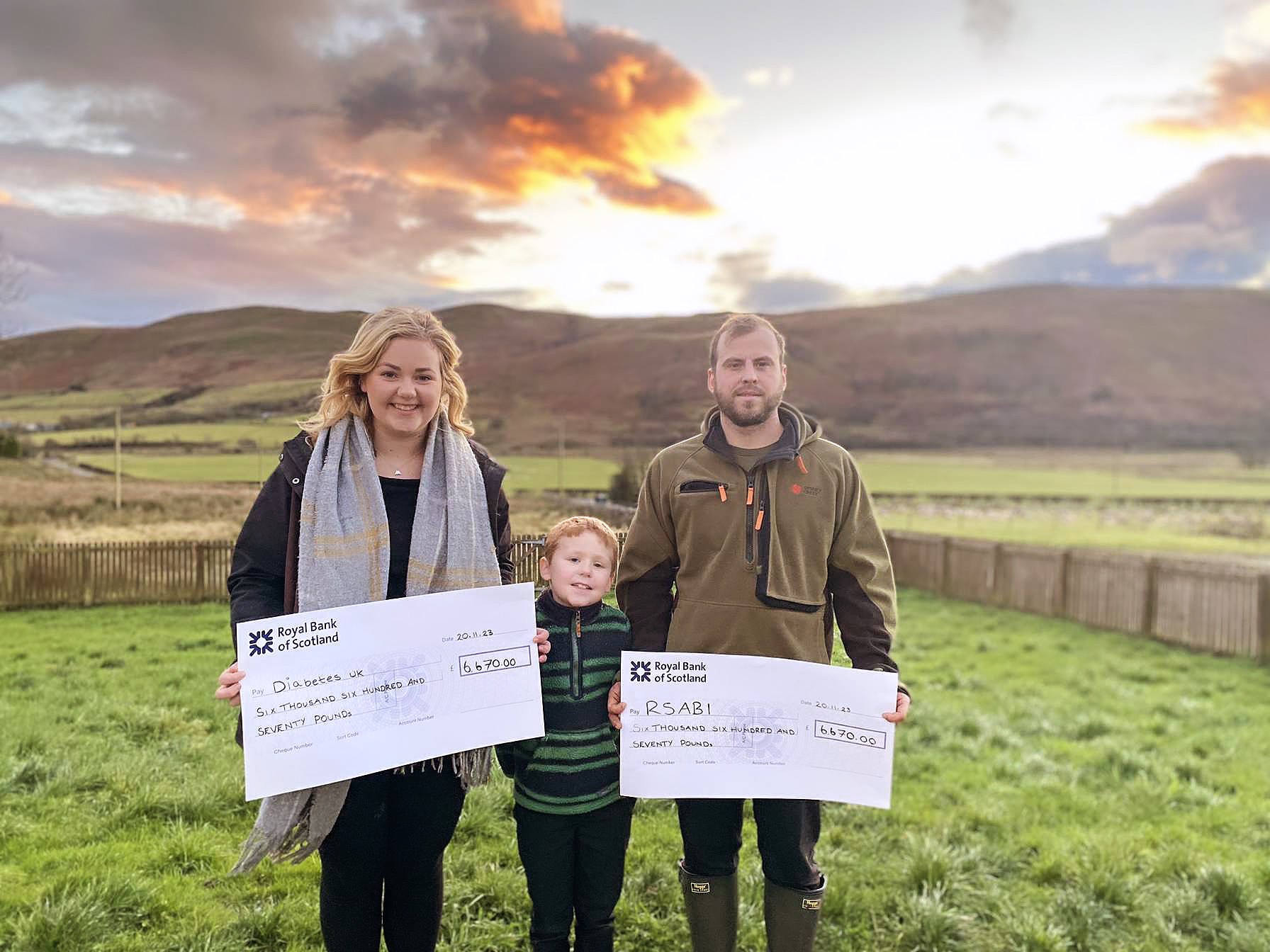 Caitlin Ross with son Ally and partner Allan in field  holding cheque (pic by RSABI)