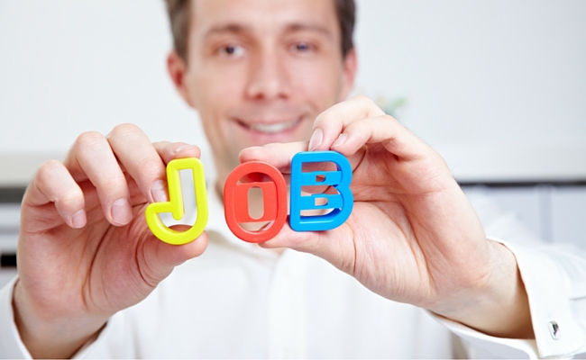 Person holding up 'Job' letters