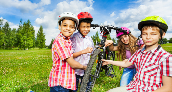 Kids with bike in field