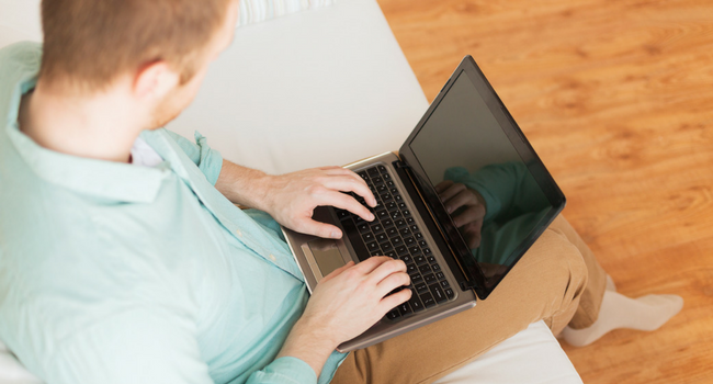 Person sitting on couch using laptop
