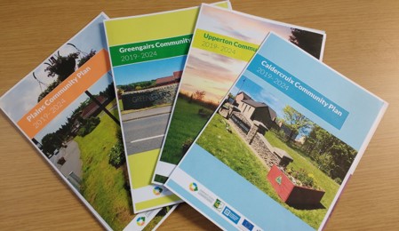 Copies of four community action plan booklets