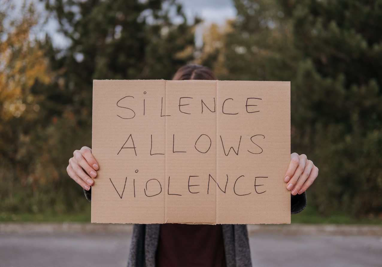 Person demonstrating with slogan silence allows violence pic Anete Lusina