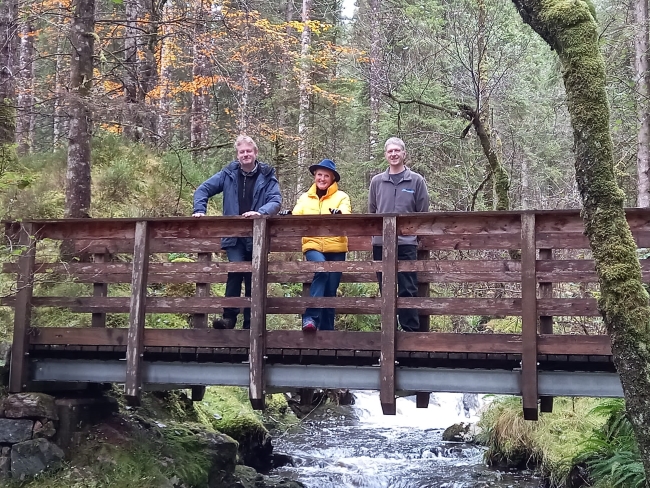 Glengarry Community Woodlands stakeholders standing on footbridge