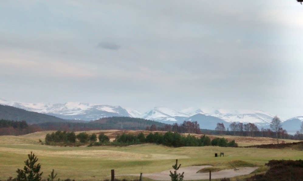 Golf course with snowy mountains