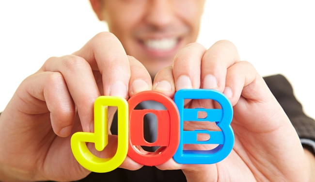 close up of person holding letter up spelling 'job'