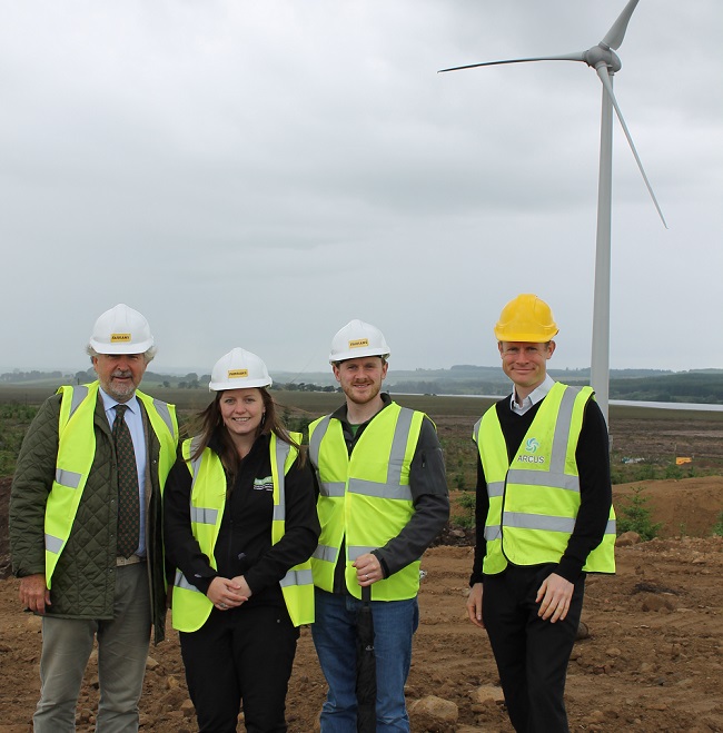 Kari Khevenhuller-Metsch (a director of LDV Harburnhead Ltd), Jemma Black (Development Officer, WAT IF?), Martin Ford-Downes (Secretary, WAT IF?), Paul Phillips (Arcus Consulting) beside wind turbine