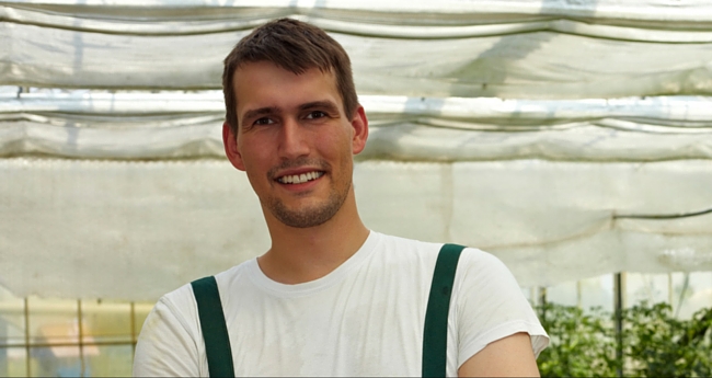 young farmer in greenhouse