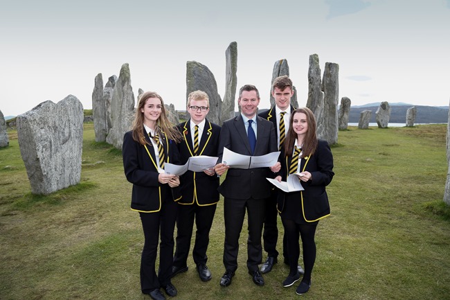 Islands Minister Derek Mackay with school pupils in front of Callanish Stones