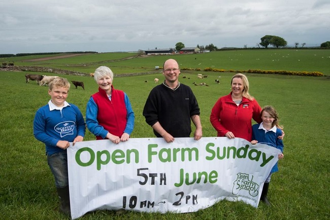 Family holding Open Farm Sunday banner