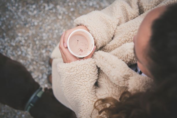 View of someone holding a warm cup with cold hands