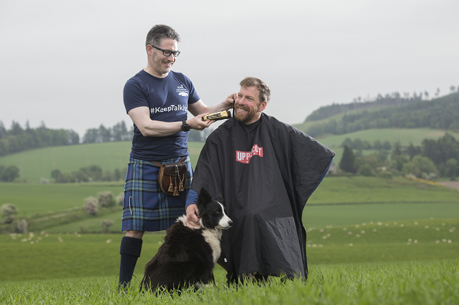 RSABI #KeepTalking ambassador Jim Smith is pictured receiving a pre Royal Highland Show tidy up with some golden Wahl clippers by the Kilted Barber, Campbell Ewen.