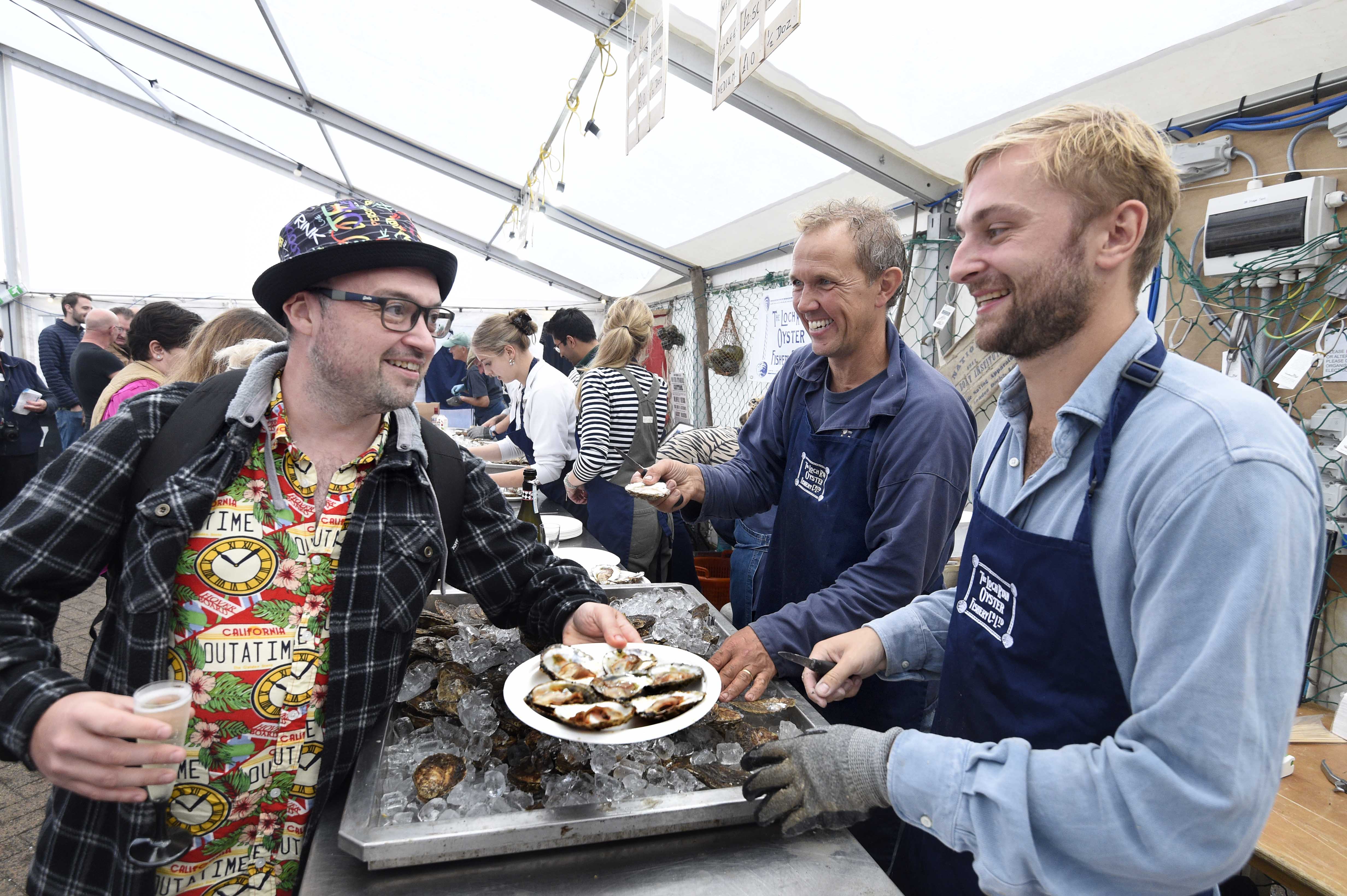 Oyster Bar at 2022 Stranraer Oyster Festival - customer receiving plate of oysters from festival staff