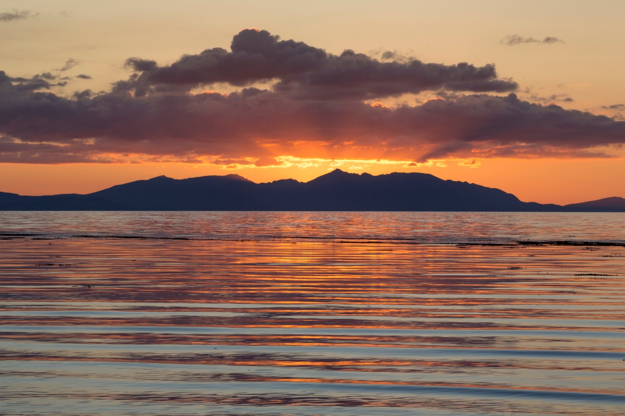 Sunset over the Isle of Arran viewed from Ayr beach. Credit: Visit Scotland/Kenny Lam