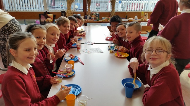 school children enjoying a farmhouse-style breakfast