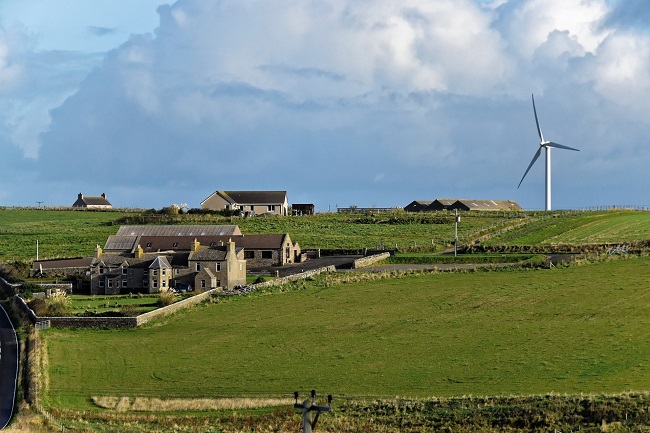 farms and wind turbine on a hill