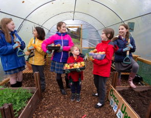 Children in polytunnel at project supported by Tesco Bags of Help