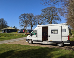 Campervan in Scottish campsite on a sunny day 