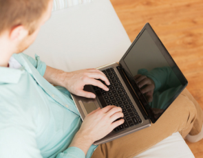 Person sitting on couch using laptop