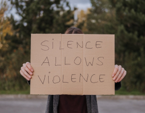 Person demonstrating with slogan silence allows violence pic Anete Lusina