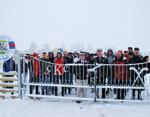 Group photo of people in the snow at the opening of Kingussie Shinty Club pitch