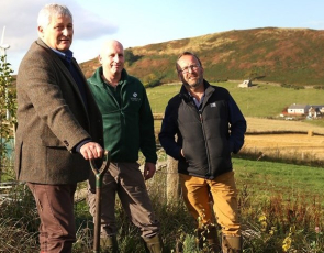 John Finnie MSP planting a Scots pine tree at Ian Mhor, near Dingwall with Willie Beattie from the Woodland Trust Scotland and crofter Jo Hunt.