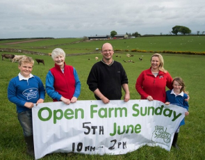 Family holding Open Farm Sunday banner