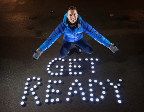 Sean Batty with 'Get Ready' written on ground with torches