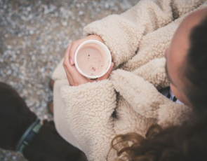 View of someone holding a warm cup with cold hands